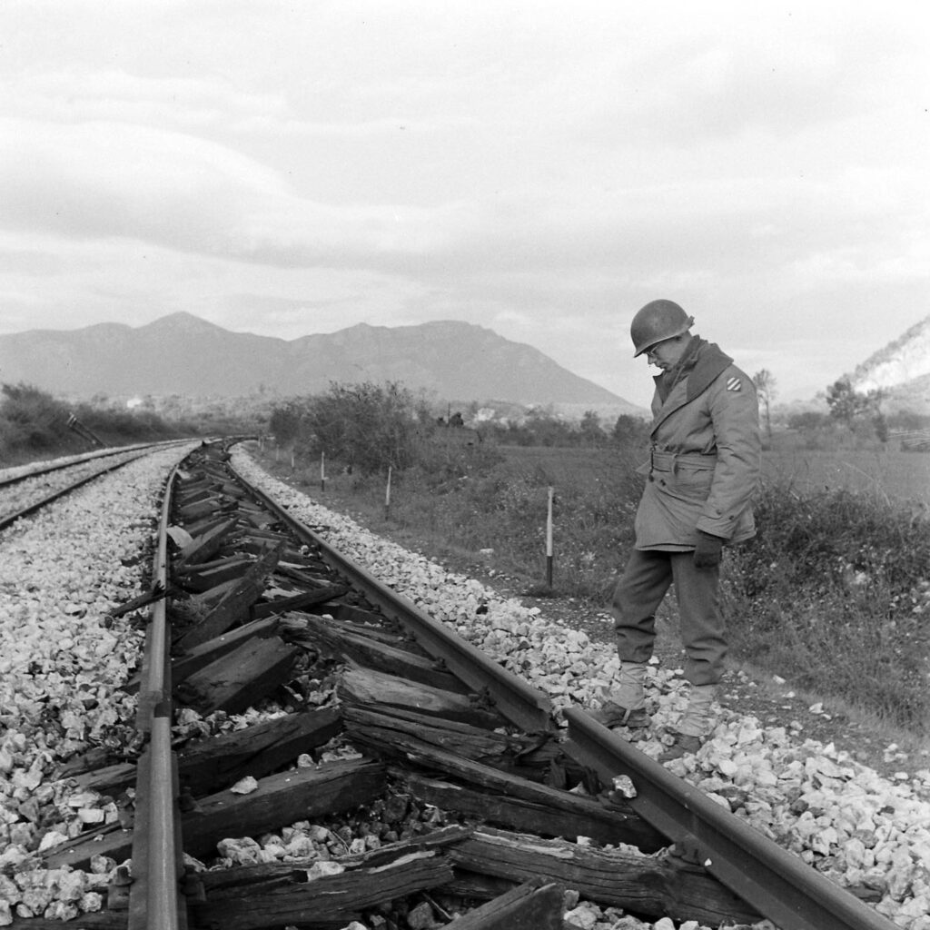Soldier with the US 3rd Infantry Division looks at railroad tracks damaged by retreating Germans with a “Railroad plough” in Italy - December 1943 LIFE Magazine Archives - George Rodger Photographer